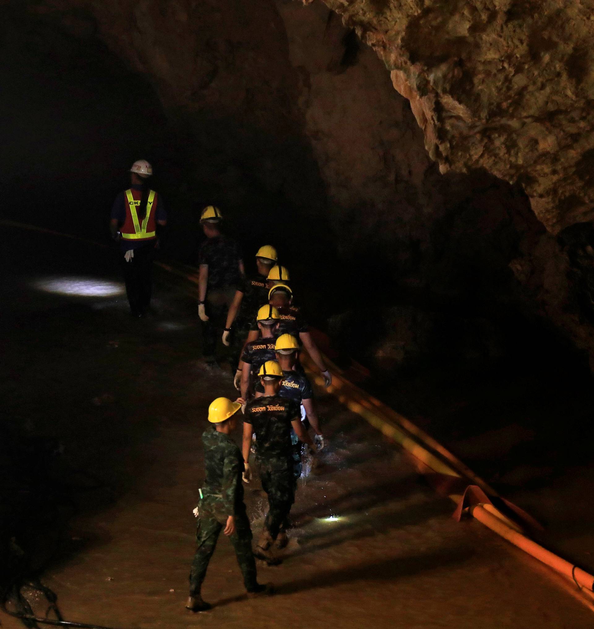 Soldiers walk after 12 soccer players and their coach were rescued near Tham Luang cave complex in the northern province of Chiang Rai