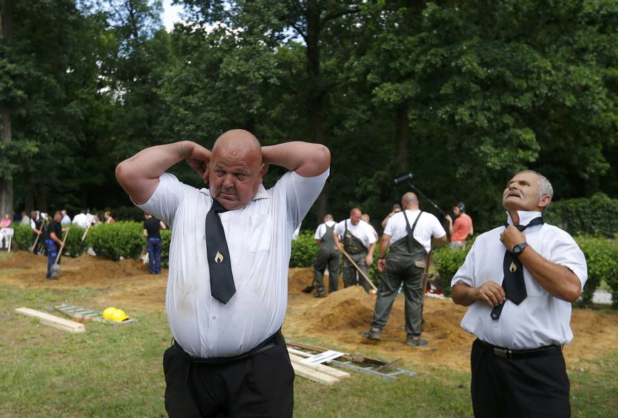 Gravediggers change into formal clothes after Hungarian grave digging championship in Debrecen