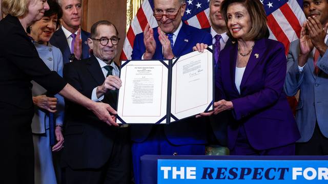 U.S. House Speaker Nancy Pelosi signs "The Respect for Marriage Act" on Capitol Hill