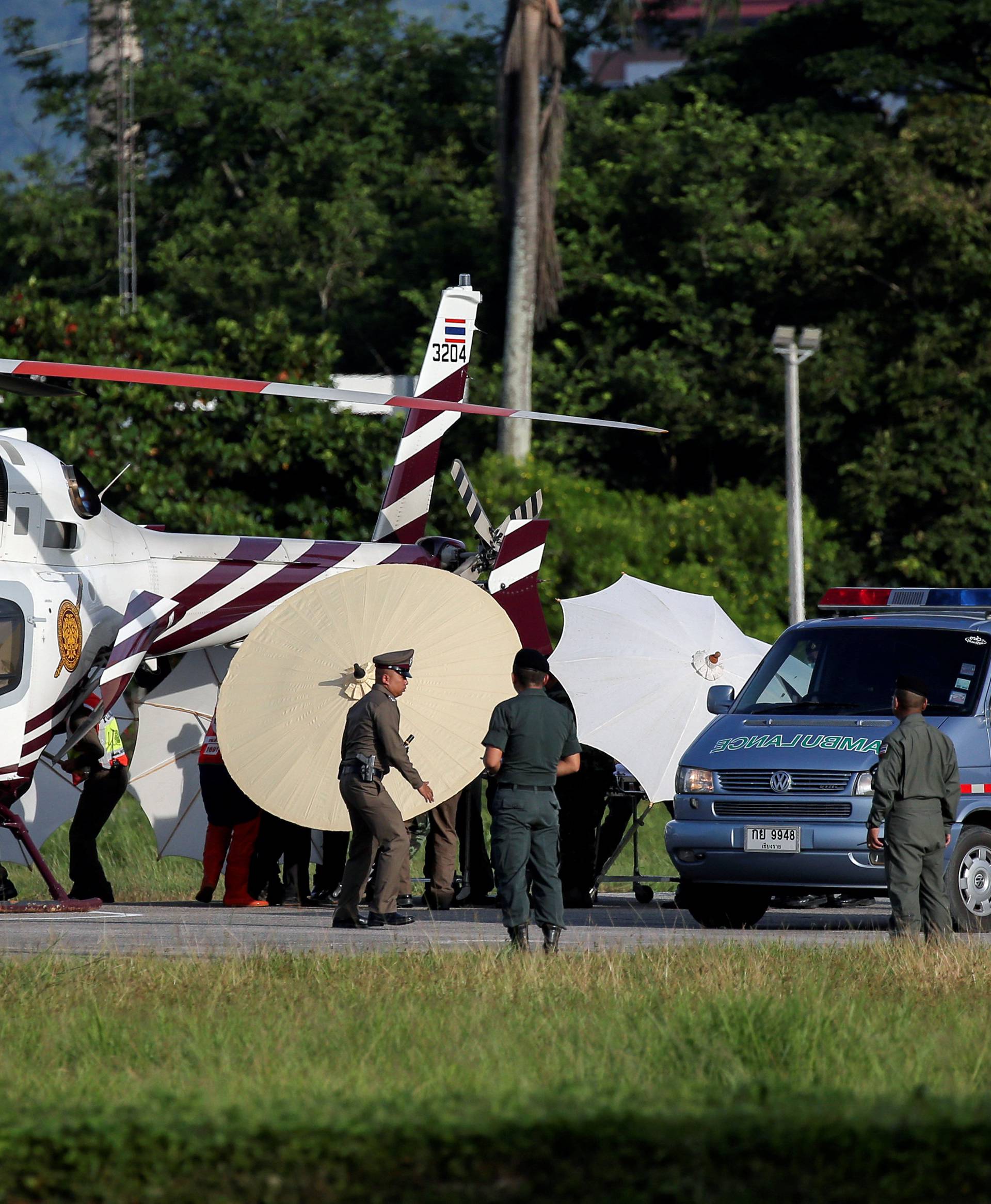 Rescued schoolboys are moved from a Royal Thai Police helicopter to an awaiting ambulance at a military airport in Chiang Rai