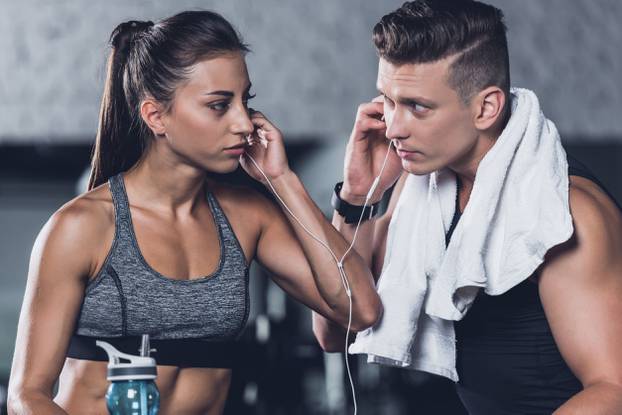 couple listening music in gym