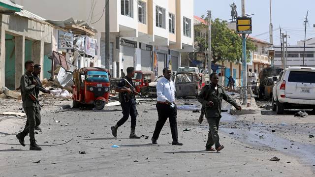 Somali policemen secure the scene of a bomb explosion at the Maka al-Mukarama street in Mogadishu