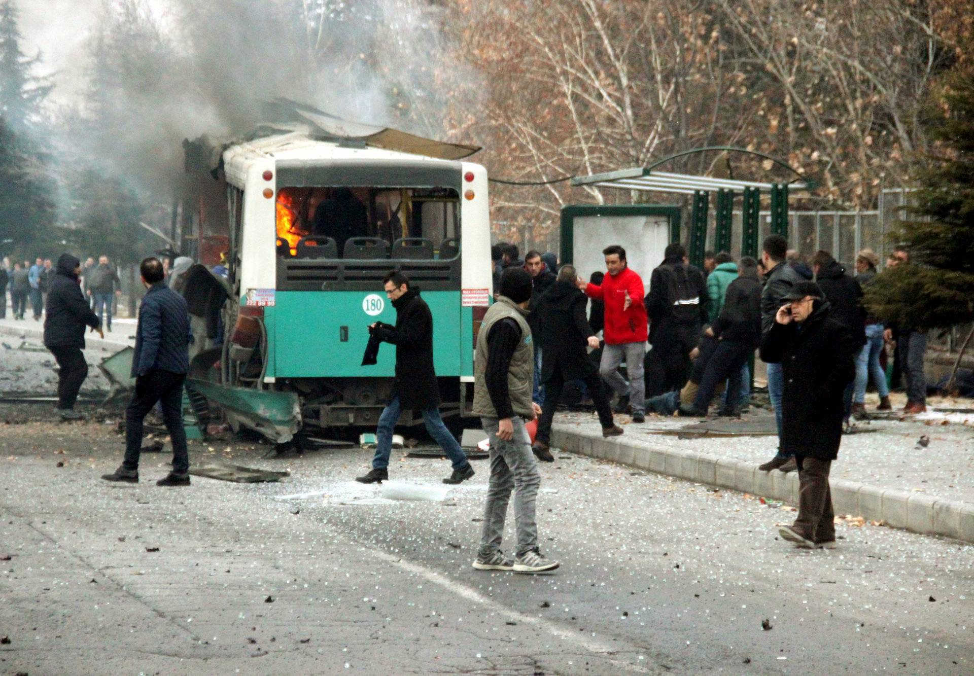 People react after a bus was hit by an explosion in Kayseri