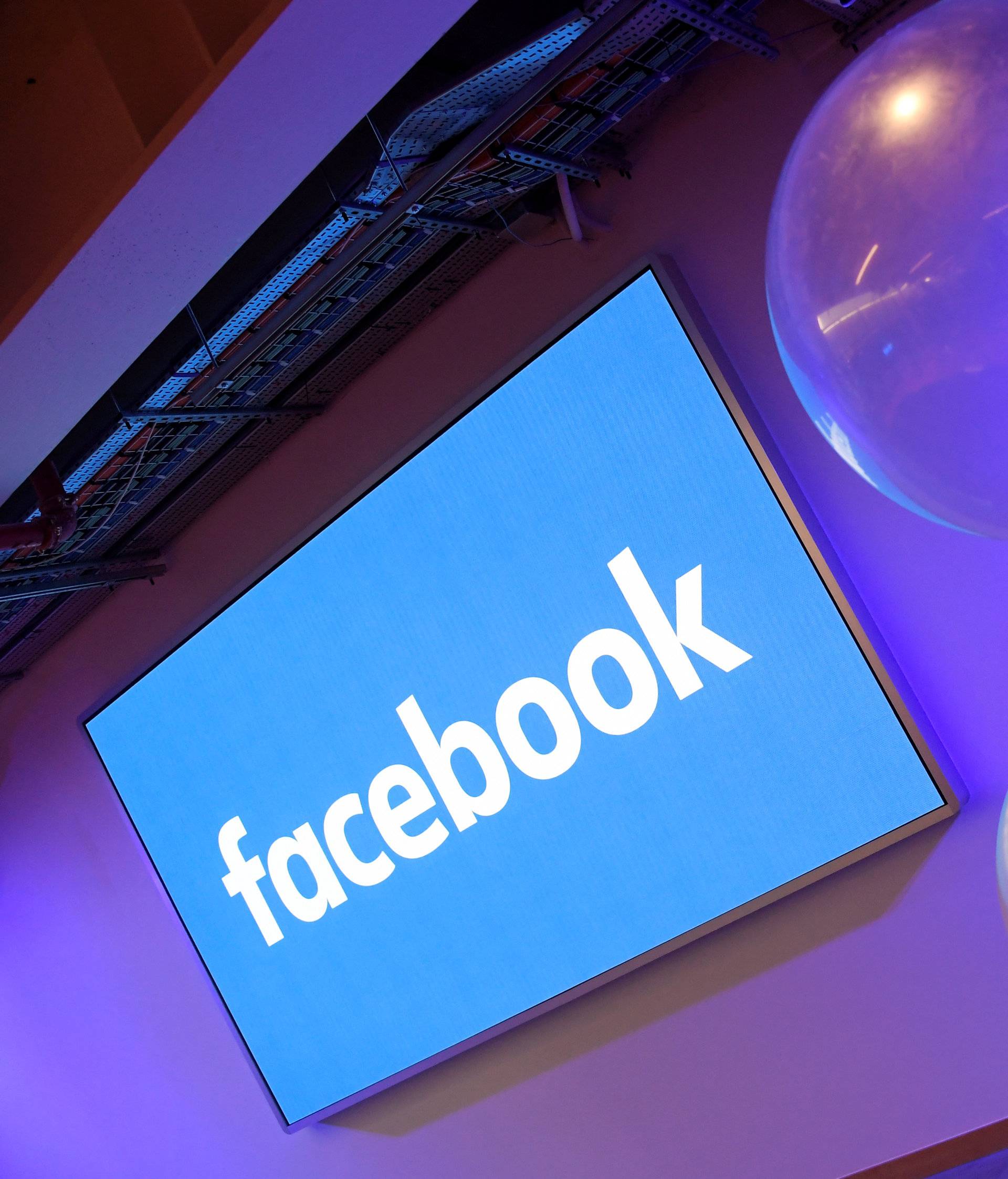 Balloons are seen in front of a logo at Facebook's headquarters in London