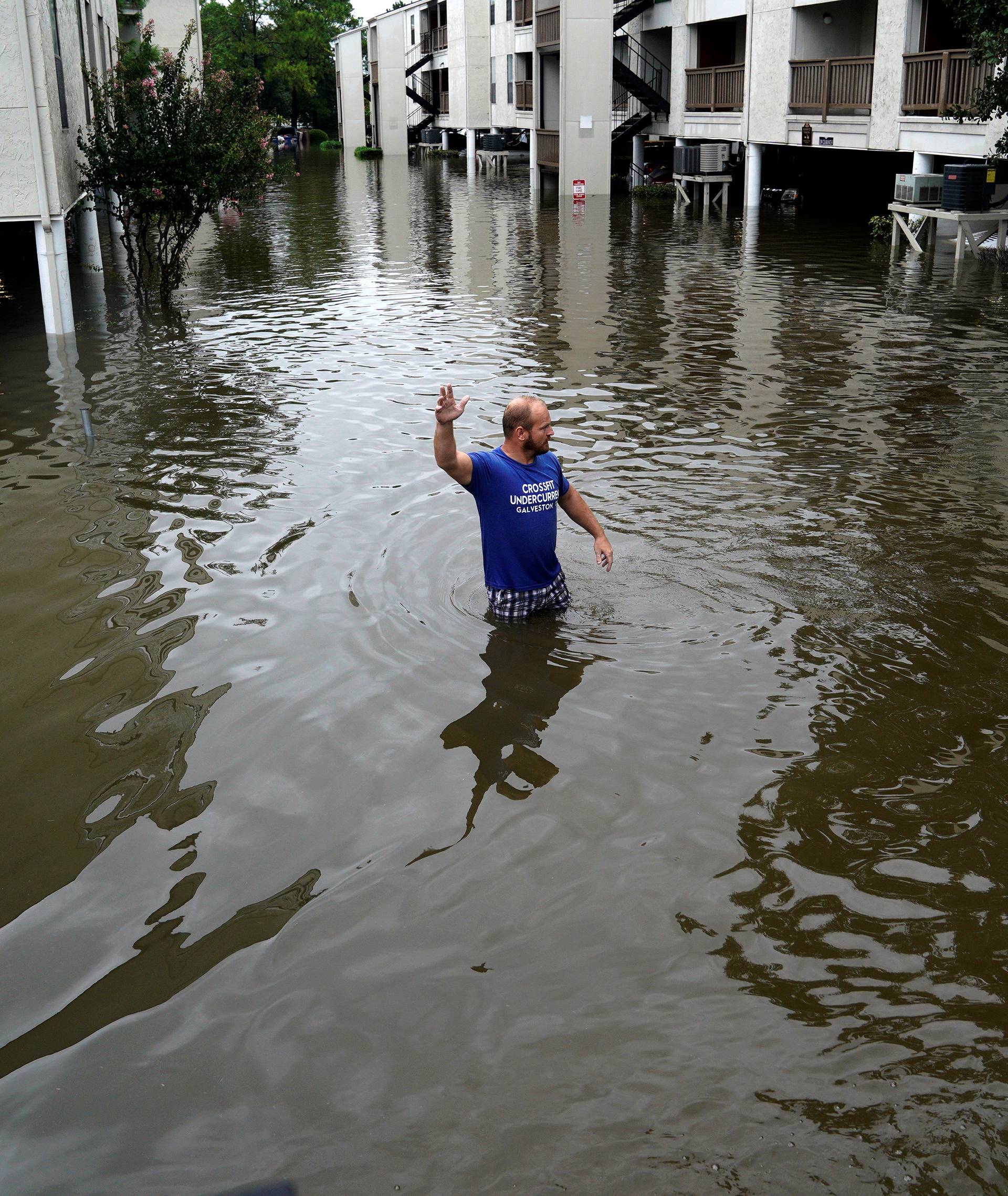 A volunteer looks for people wanting to be evacuated from the Hurricane Harvey floodwaters in Dickinson