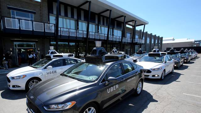 FILE PHOTO: A fleet of Uber's Ford Fusion self driving cars are shown during a demonstration of self-driving automotive technology in Pittsburgh