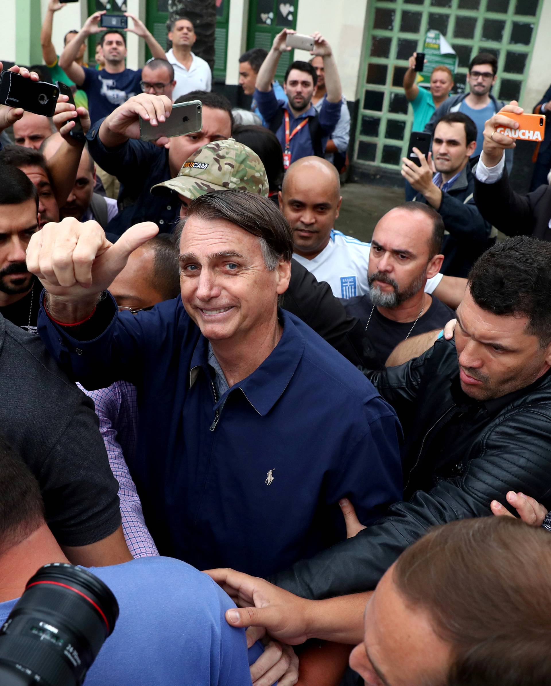 Jair Bolsonaro, far-right lawmaker and presidential candidate of the Social Liberal Party (PSL), gestures after casting his vote, in Rio de Janeiro