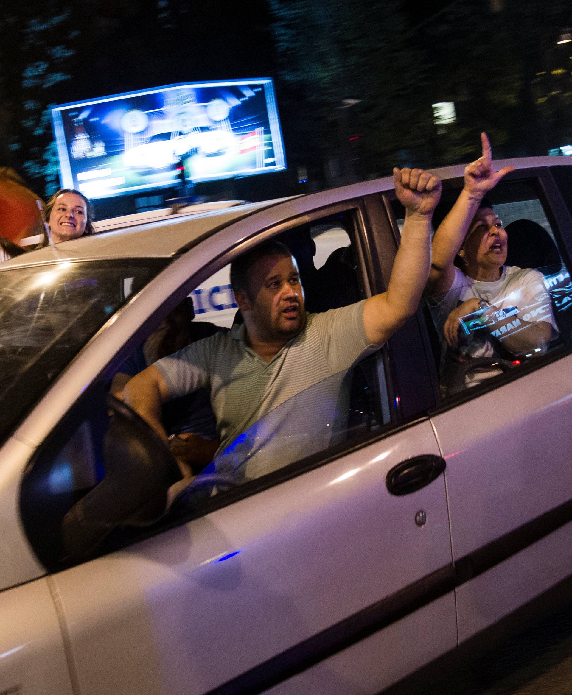 Supporters of Milo Djukanovic, the presidential candidate of the ruling DPS party celebrate his victory in Podgorica