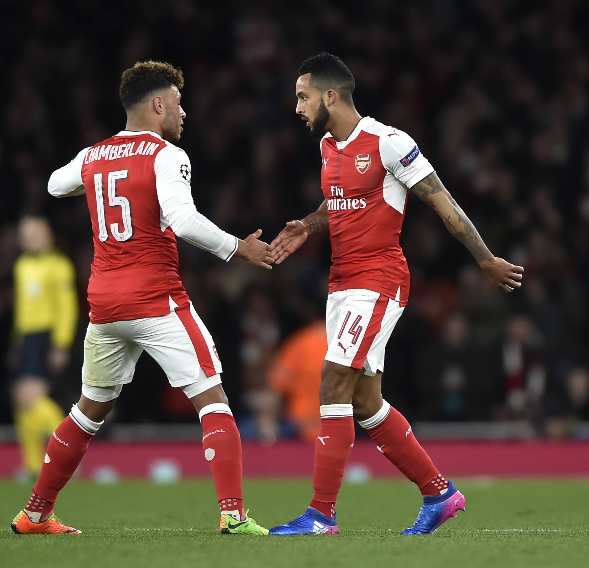 Arsenal's Theo Walcott celebrates scoring their first goal with Alex Oxlade-Chamberlain