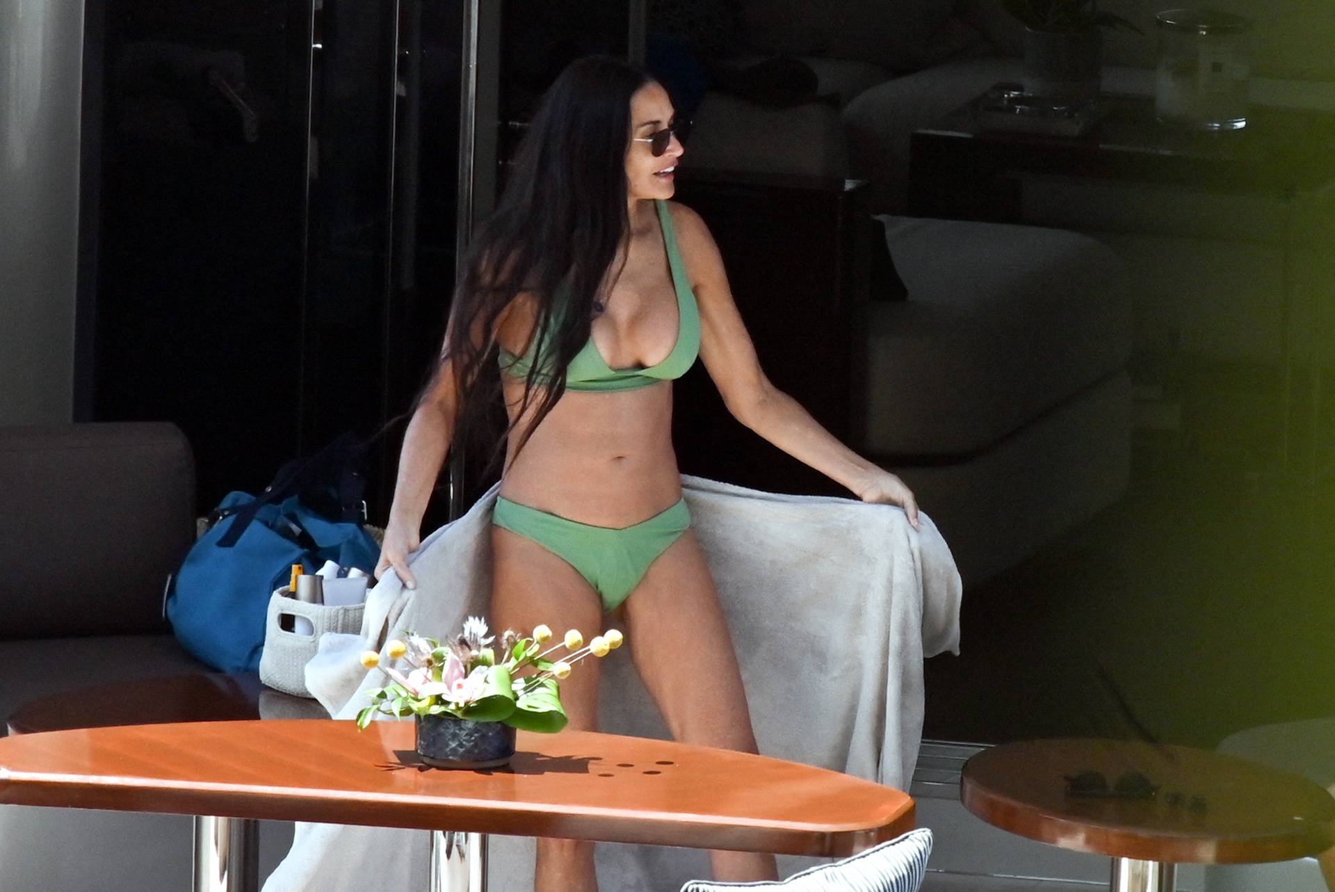 PREMIUM EXCLUSIVE: *NO WEB UNTIL 4PM EDT 14TH AUG* Demi Moore shows off her amazing curves in a daring green bikini proving she’s still sexy at 60