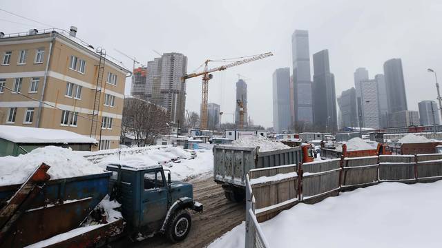 Trucks transporting snow are seen on their way to a snow melting plant in Moscow