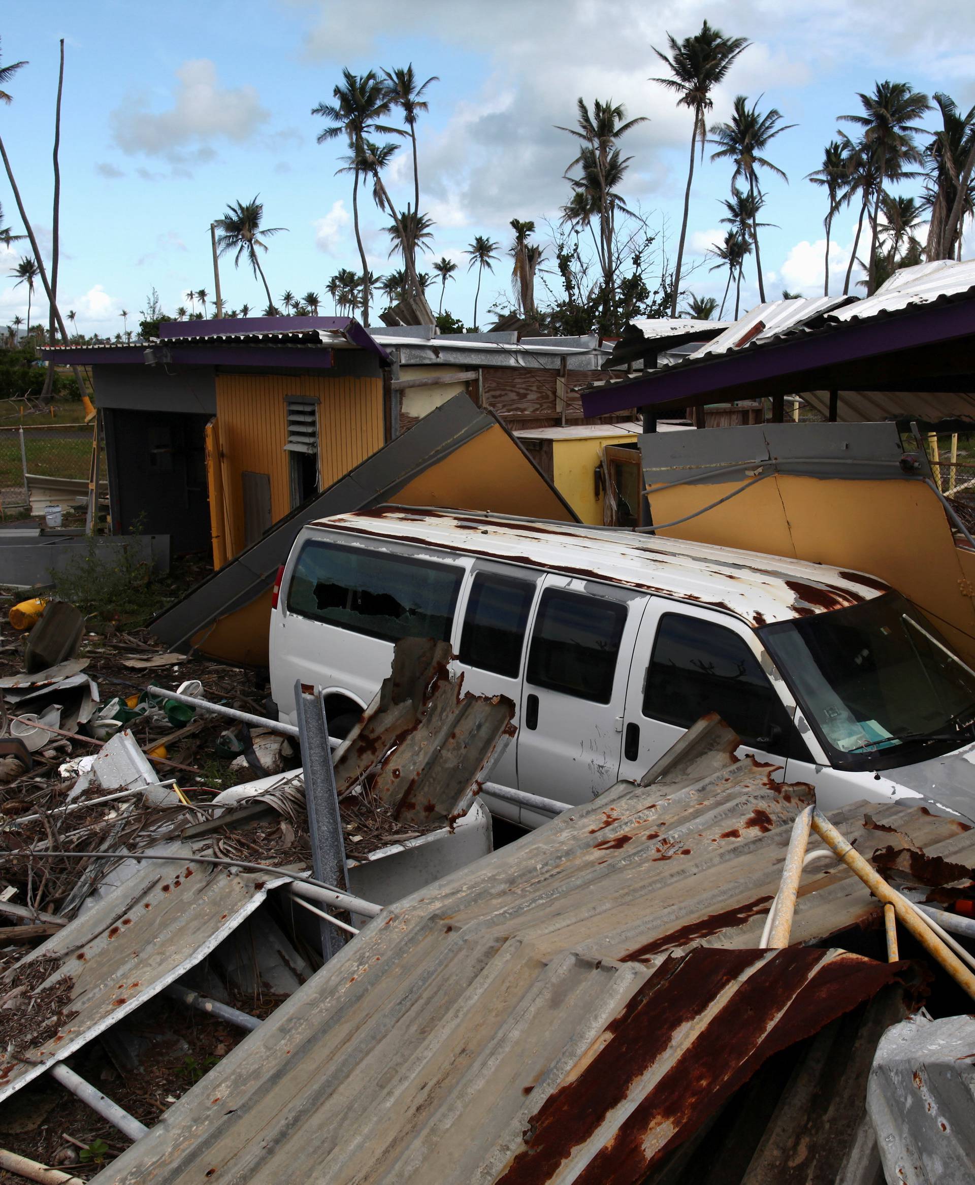 FILE PHOTO:  A car is partially buried under the remains of a building, after Hurricane Maria hit the island in September, in Humacao