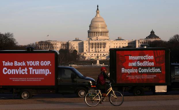 Trucks advertising in support of convicting former U.S President Donald Trump in his upcoming second impeachment trial are seen parked on the National Mall with the U.S. Capitol Building visible behind them in Washington