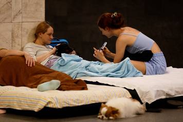People take shelter inside a metro station during an air raid alert in Kyiv