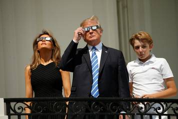 U.S. President Trump watches the solar eclipse with first Lady Melania Trump and son Barron from the Truman Balcony at the White House in Washington