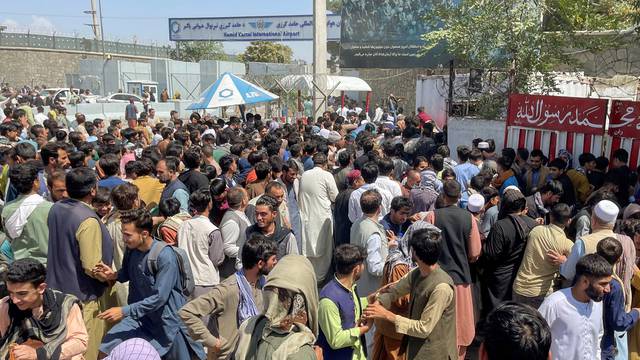People try to get into Hamid Karzai International Airport in Kabul