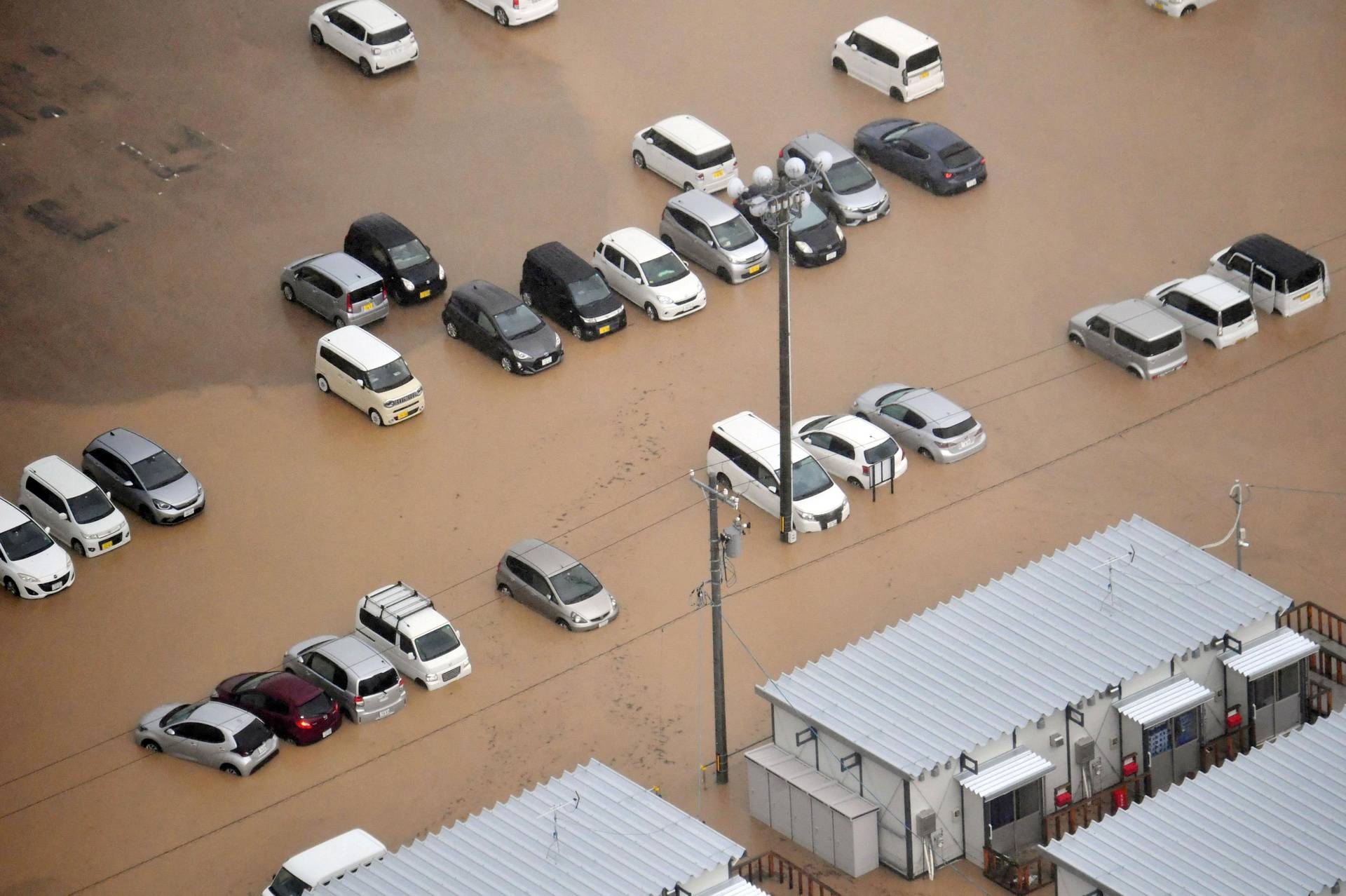 An aerial view shows flooded cars and temporary houses for residents forced to evacuate due to the January 2024 earthquake in Wajima