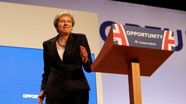 British Prime Minister Theresa May arrives on stage dancing to Abba's 'Dancing Queen' before delivering her keynote address on the final day of at the Conservative Party Conference in Birmingham