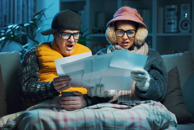 Sad,Couple,Feeling,Cold,At,Home,And,Checking,Expensive,Utility