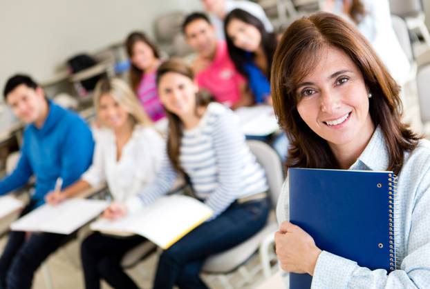 Older,Female,Student,In,Class,Holding,A,Notebook