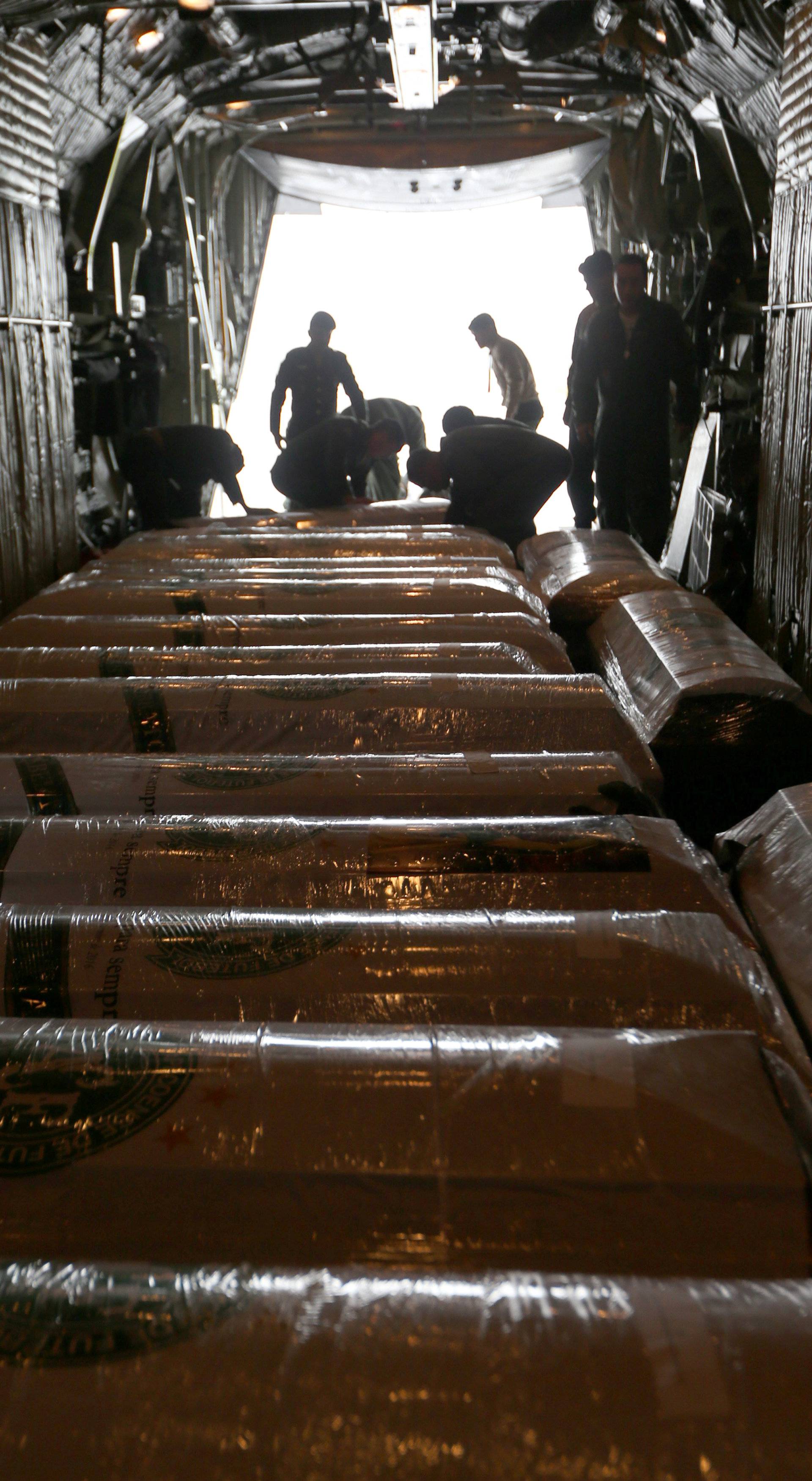 Coffins cointaining the mortal remains of victims of the plane crash in Colombia are seen inside the plane after arriving in Chapeco