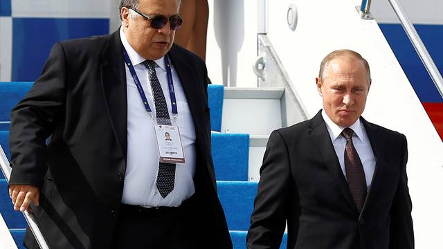 FILE PHOTO: Russian Ambassador to Turkey Andrey Karlov accompanies Russian President Vladimir Putin who disembarks from the Presidential aircraft at Ataturk airport in Istanbul