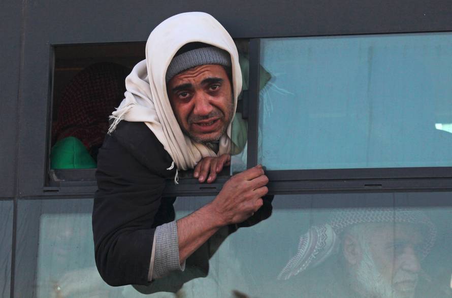 Evacuees from rebel-held east Aleppo, arrive at the town of al-Rashideen, which is held by insurgents, just outside the city