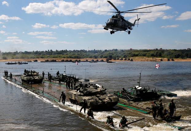 Russian crew members transport T-80 tanks on pontoon bridge during Open Water competition at International Army Games 2016 in Murom