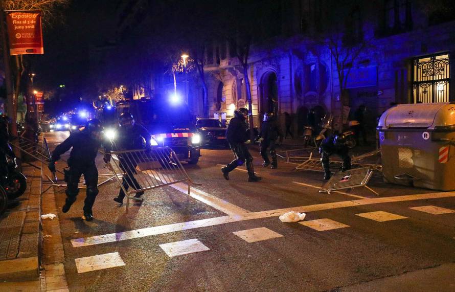 Catalan police remove barricades placed by protestors during skirmishes after former regional president Carles Puigdemont was detained in Germany,  in Barcelona