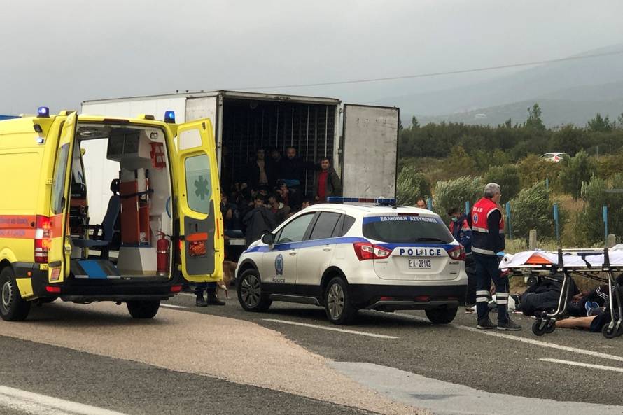 Migrants are seen inside a refrigerated truck found by police, after a check at a motorway near Xanthi