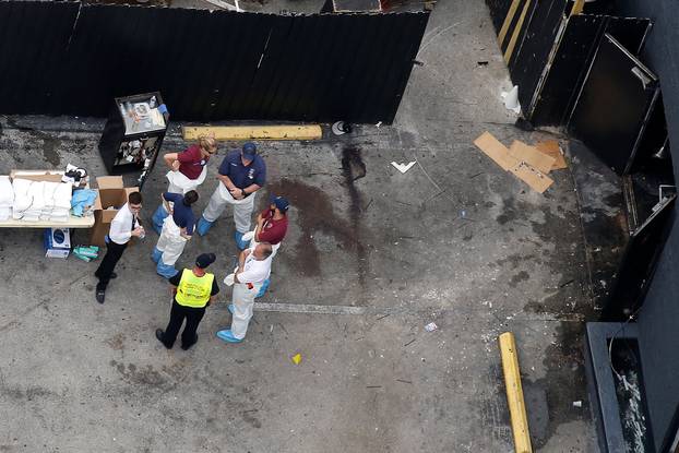 Investigators work the scene following a mass shooting at the Pulse gay nightclub in Orlando Florida