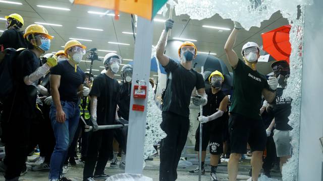 Protesters break the windows of the Legislative Council building on the anniversary of Hong Kong's handover to China in Hong Kong
