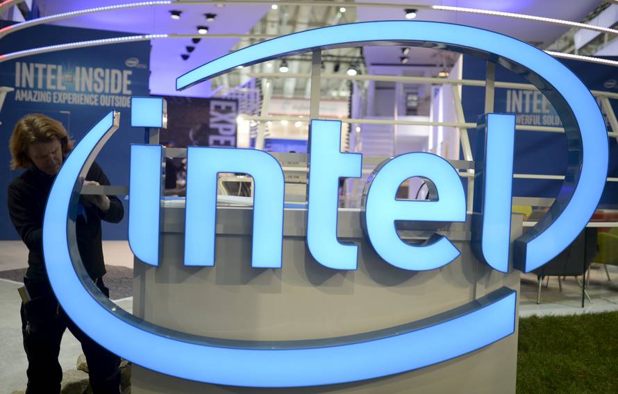File photo of a worker arranging Intel logo at CeBIT trade fair in Hannover