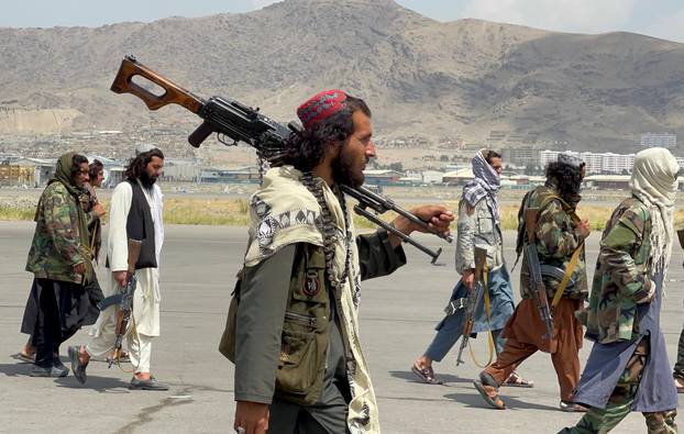 FILE PHOTO: Taliban forces patrol at a runway a day after U.S troops withdrawal from Hamid Karzai International Airport in Kabul