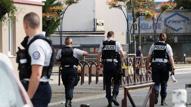 Police secure the area during an operation after components that can be used to make explosives were found in a flat in Villejuif