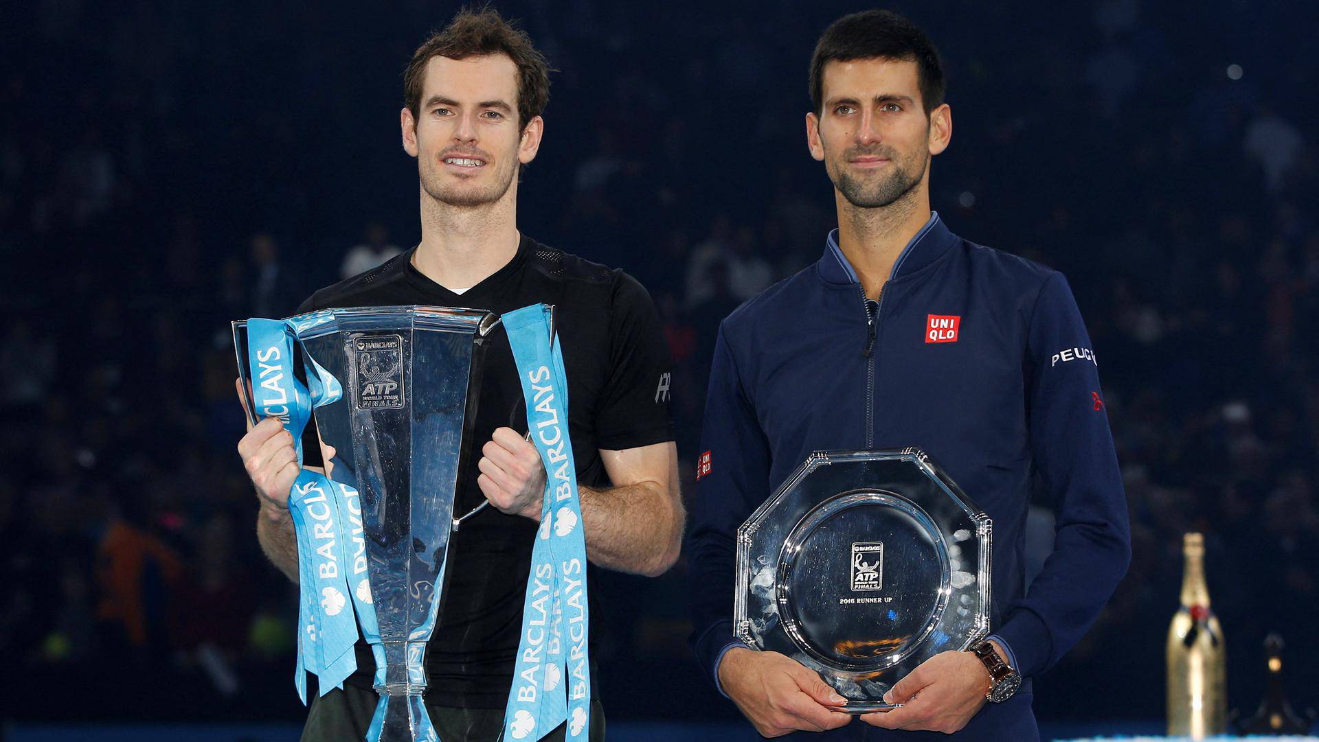 FILE PHOTO: Britain's Andy Murray and Serbia's Novak Djokovic with their trophies after the final