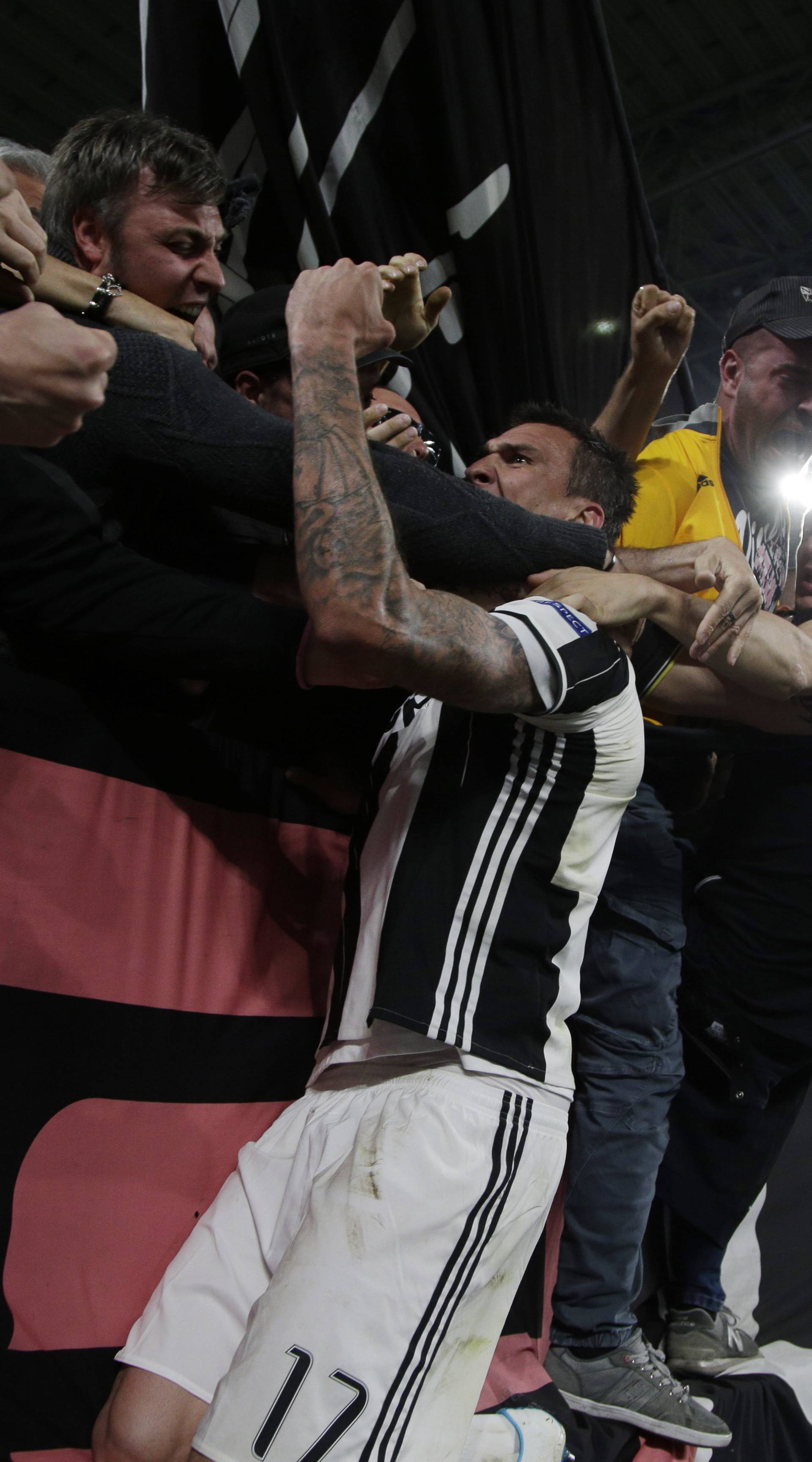 Juventus' Mario Mandzukic celebrates scoring their first goal with fans