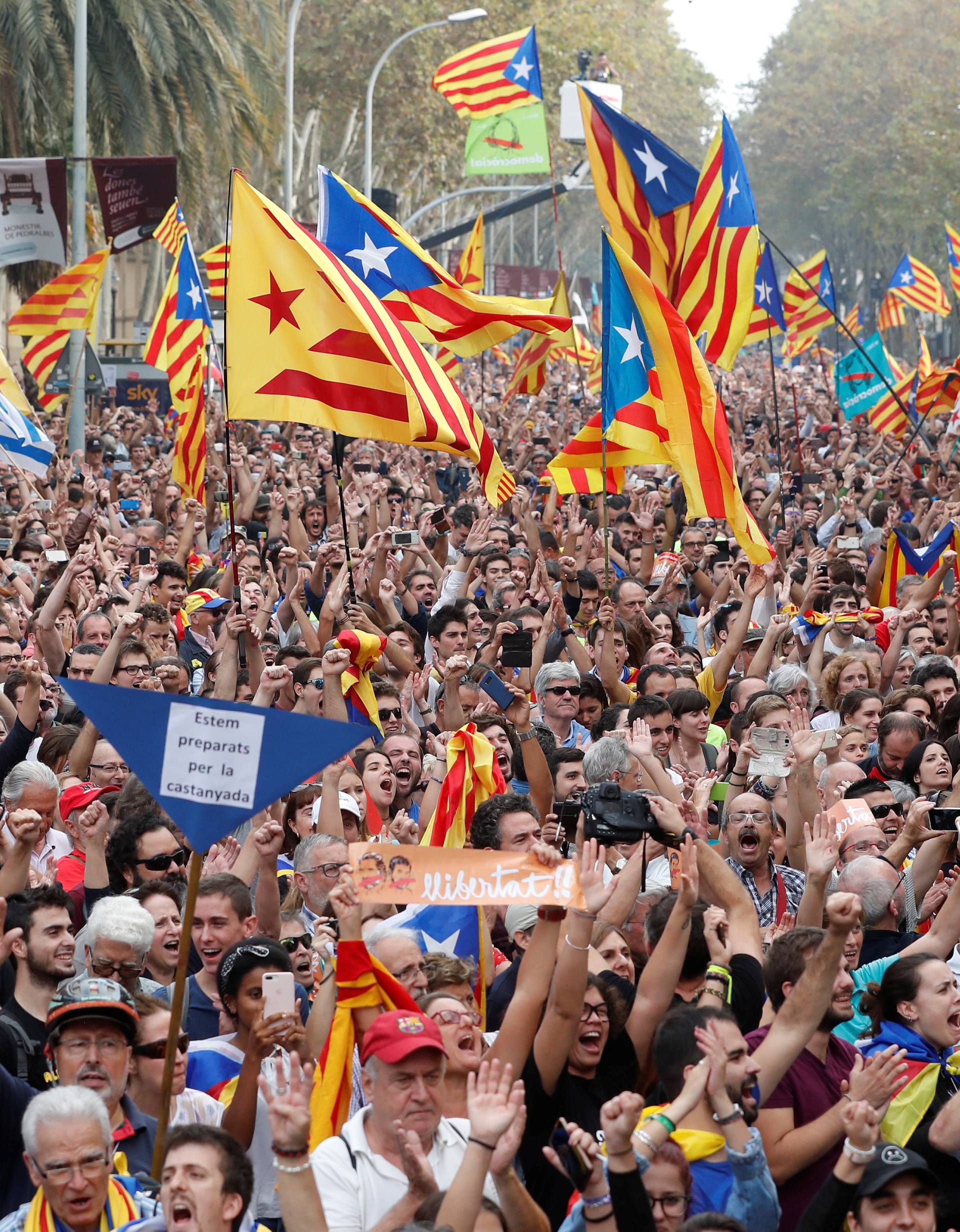 People celebrate after the Catalan regional parliament passes the vote of independence from Spain in Barcelona