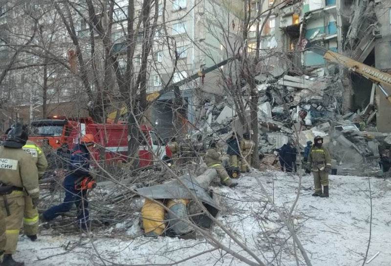 Emergency personnel work at the site of collapsed apartment building after a suspected gas blast in Magnitogorsk