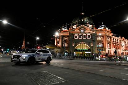 A police car is seen outside a transit hub after a citywide curfew was introduced to slow the spread of COVID-19 in Melbourne