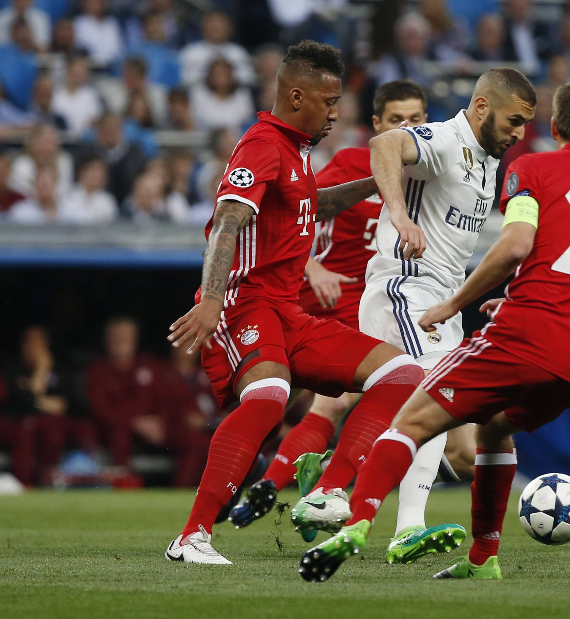 Real Madrid's Karim Benzema in action with Bayern Munich's Jerome Boateng and Philipp Lahm