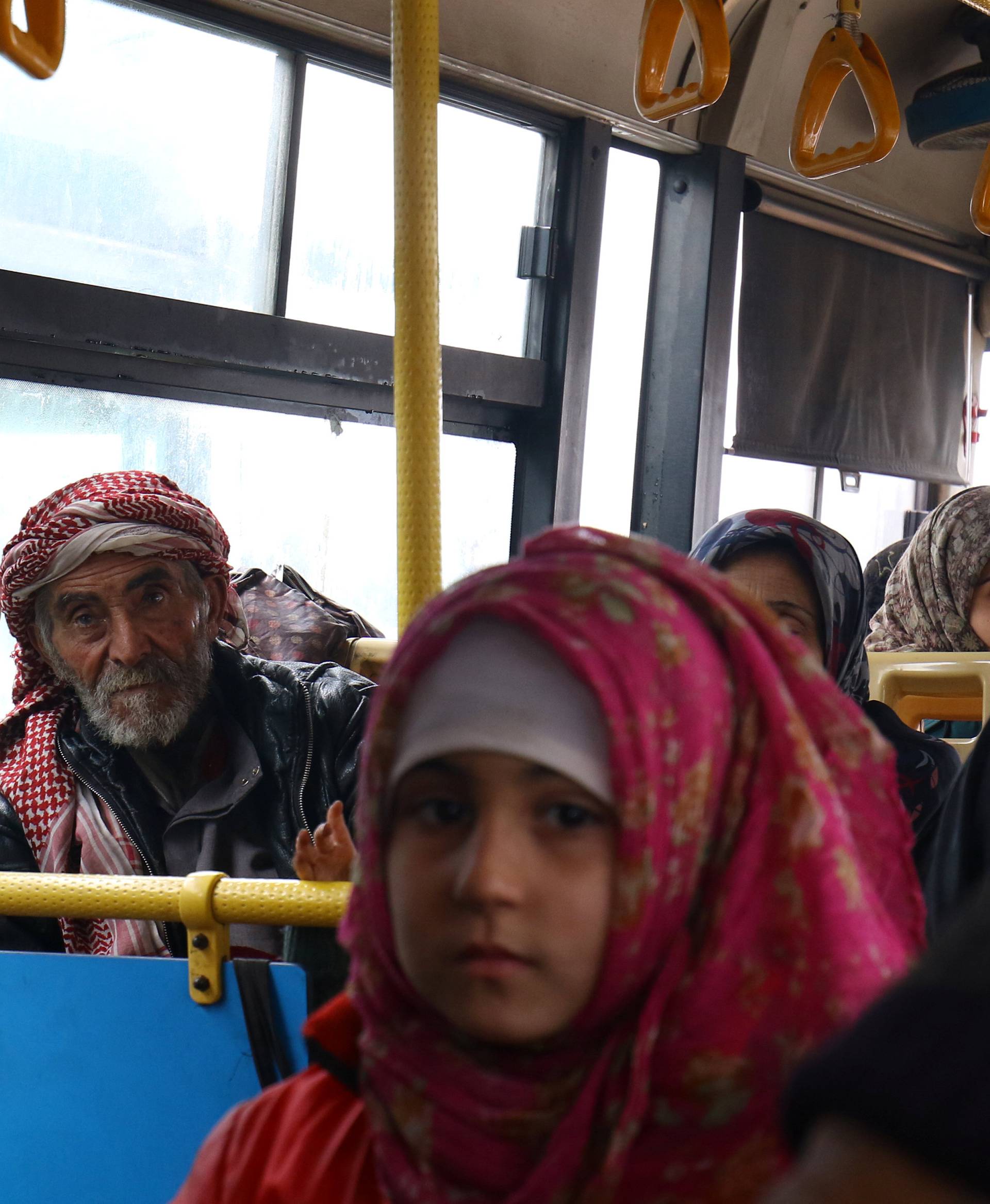 Evacuees from the Shi'ite Muslim villages of al-Foua and Kefraya ride a bus at insurgent-held al-Rashideen in the province of Aleppo