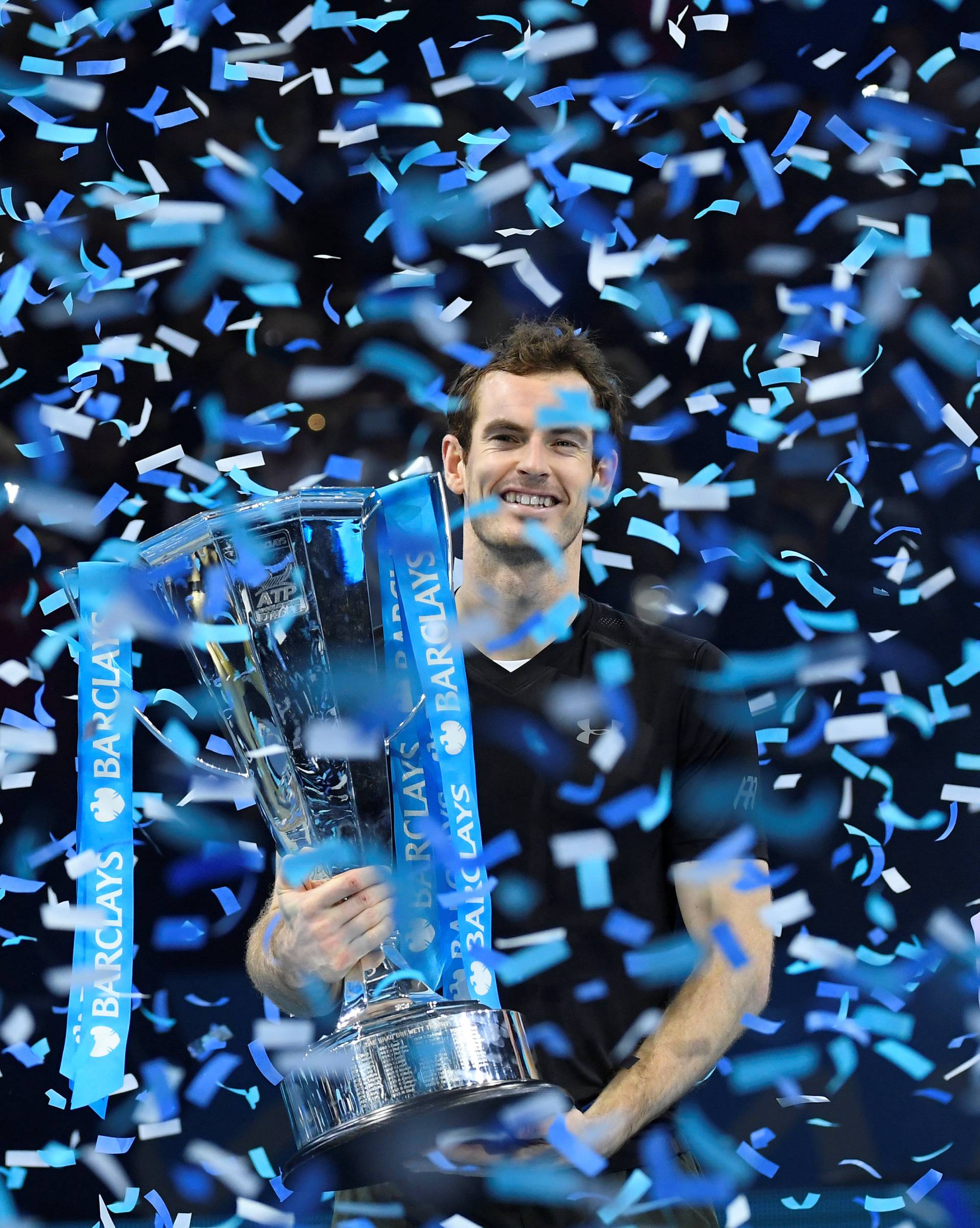 FILE PHOTO: Great Britain's Andy Murray celebrates with the ATP World Tour Finals trophy at O2 Arena, London - 20/11/16