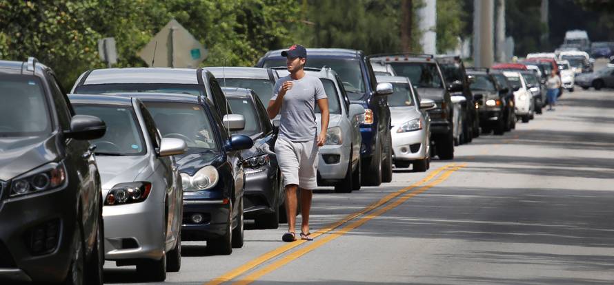 People in their vehicles wait in queue to get sandbags at Kissimmee, in preparation for the arrival of Hurricane Irma making landfall, in Florida