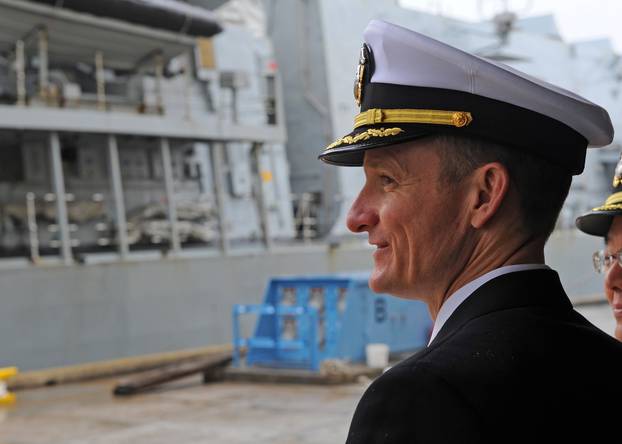 Captain Brett E. Crozier watches Royal Navy HMS Sutherland as she arrives in Yokosuka