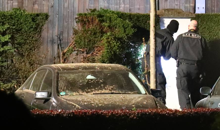 Forensic experts search the area where the expolsion occured