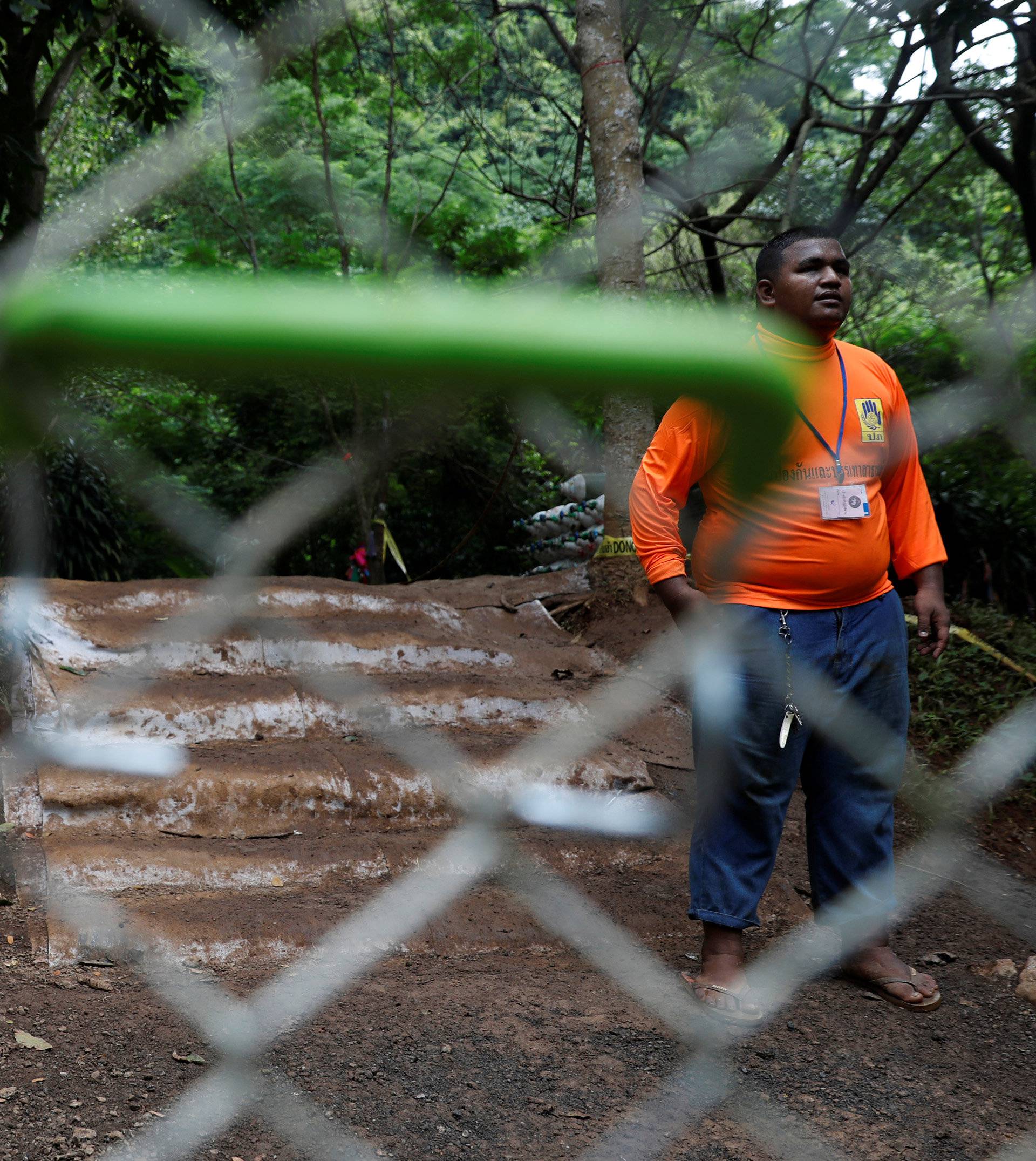 A rescue worker walks out from Tham Luang cave complex in the northern province of Chiang Rai