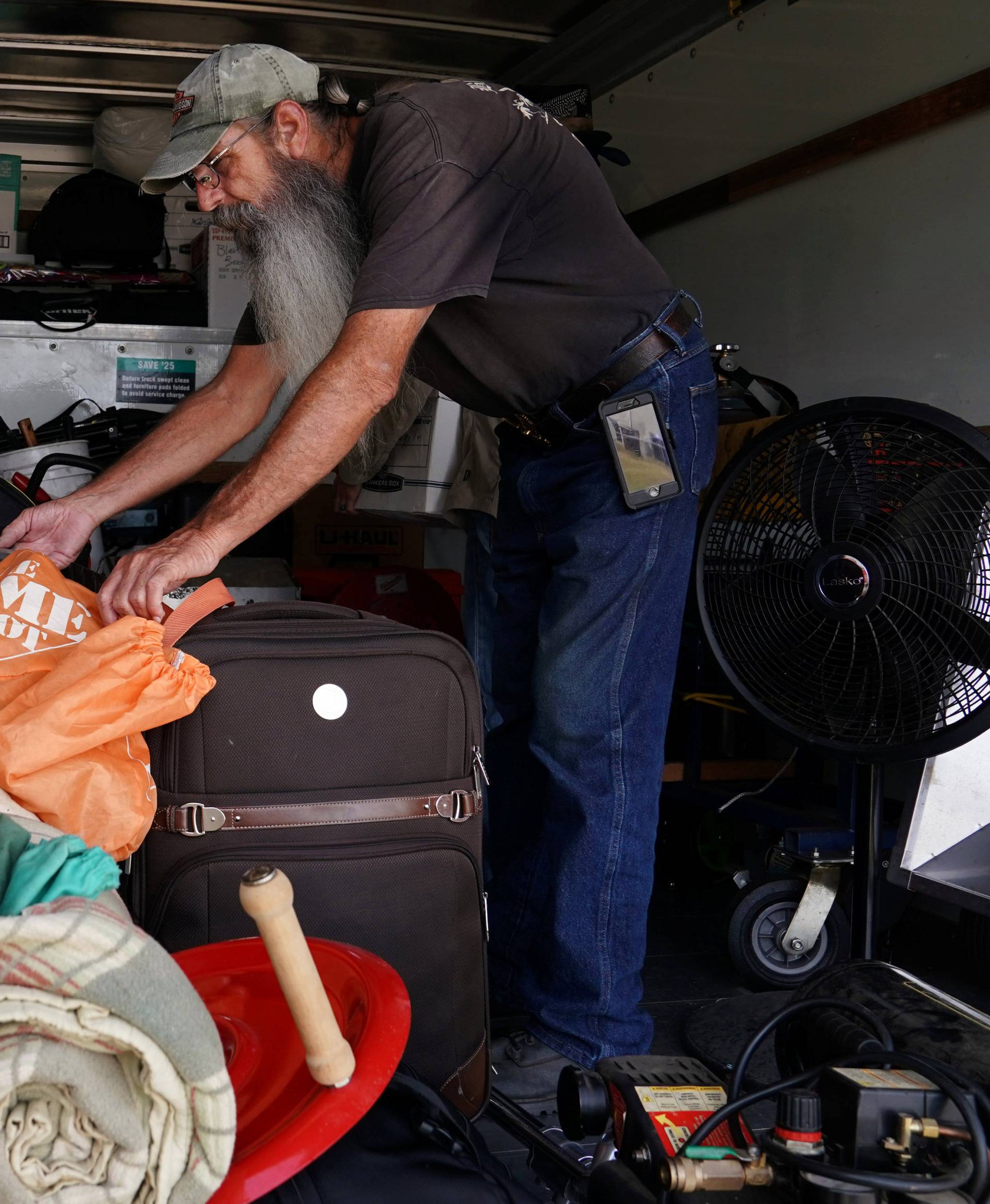 Mike Driver loads his possessions into a rental truck before Hurricane Florence comes ashore in Carolina Beach