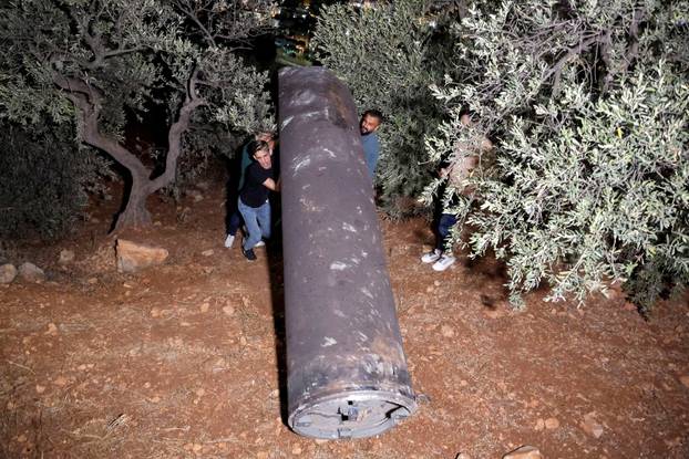 Palestinians investigate a projectile, after Iran fired a salvo of ballistic missiles, in Tubas