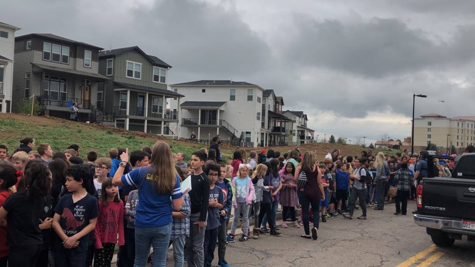 People wait outside near the STEM School during a shooting incident in Highlands Ranch, Colorado, U.S. in this May 7, 2019 image obtained via social media